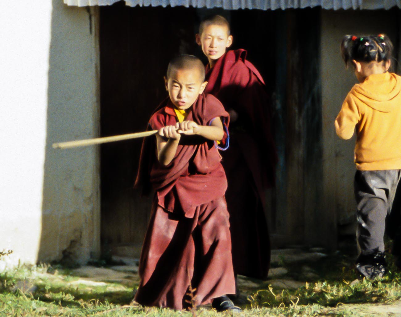 Two boy monks playing In Zhongdian's Songzanlin Monastery near the border of Tibet and China ©2013 Nick Katin