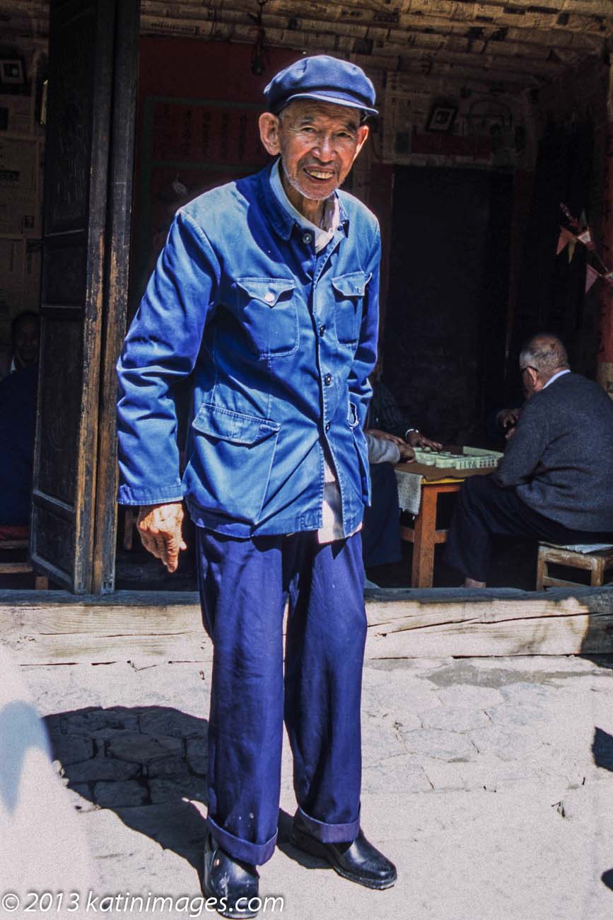 Man in a  Zhongshan or Mao  suit posing in the village Xizhou near Dali in the Yunnan province of China
