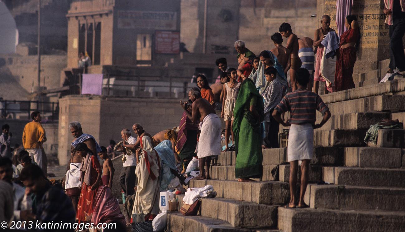 Pilgrims on the Ghats. People on the Ghats or steps on the banks of the river Ganges in Varanasi, India
