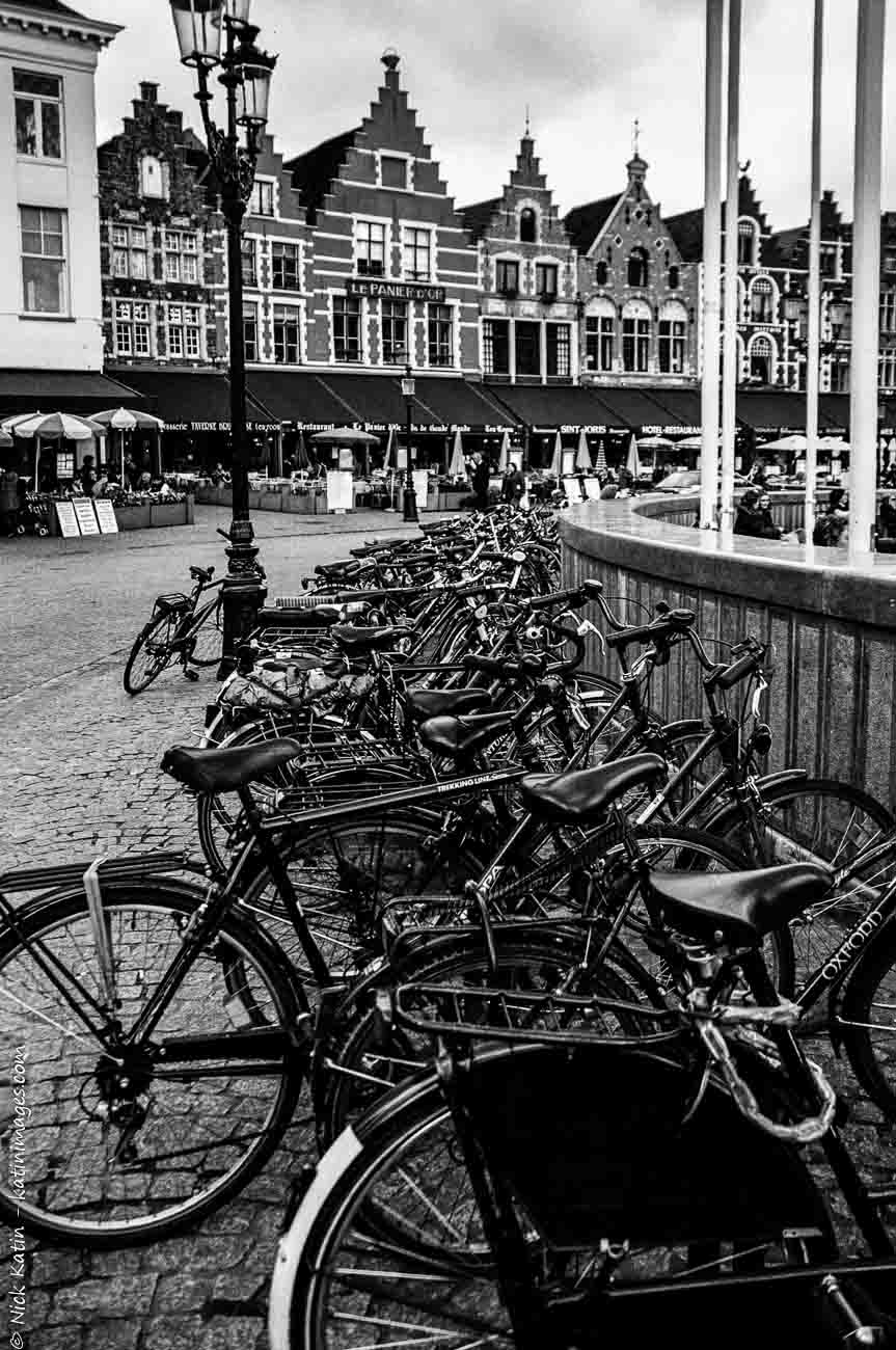 Bicycles in clock tower plaza in Bruges, the 'Venice of northern Europe",Belgium