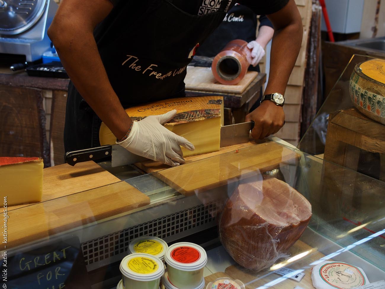 Cutting cheese at one of London's famous markets, Borough Markets which is devoted entirely to food.