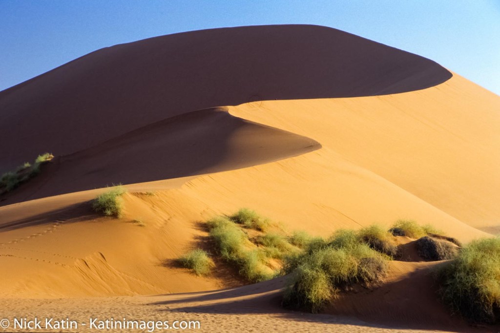 Sossusvlei is a salt and clay pan surrounded by high red dunes, located in the southern part of the Namib Desert, in the Namib-Naukluft National Park of Namibia