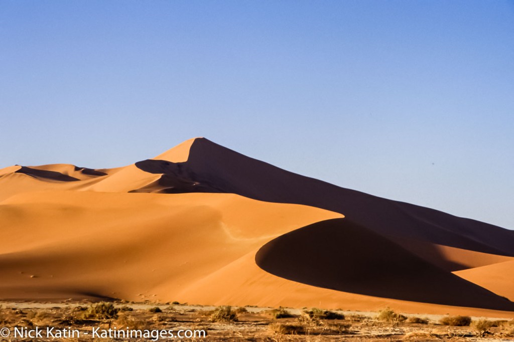 Sossusvlei is a salt and clay pan surrounded by high red dunes, located in the southern part of the Namib Desert, in the Namib-Naukluft National Park of Namibia