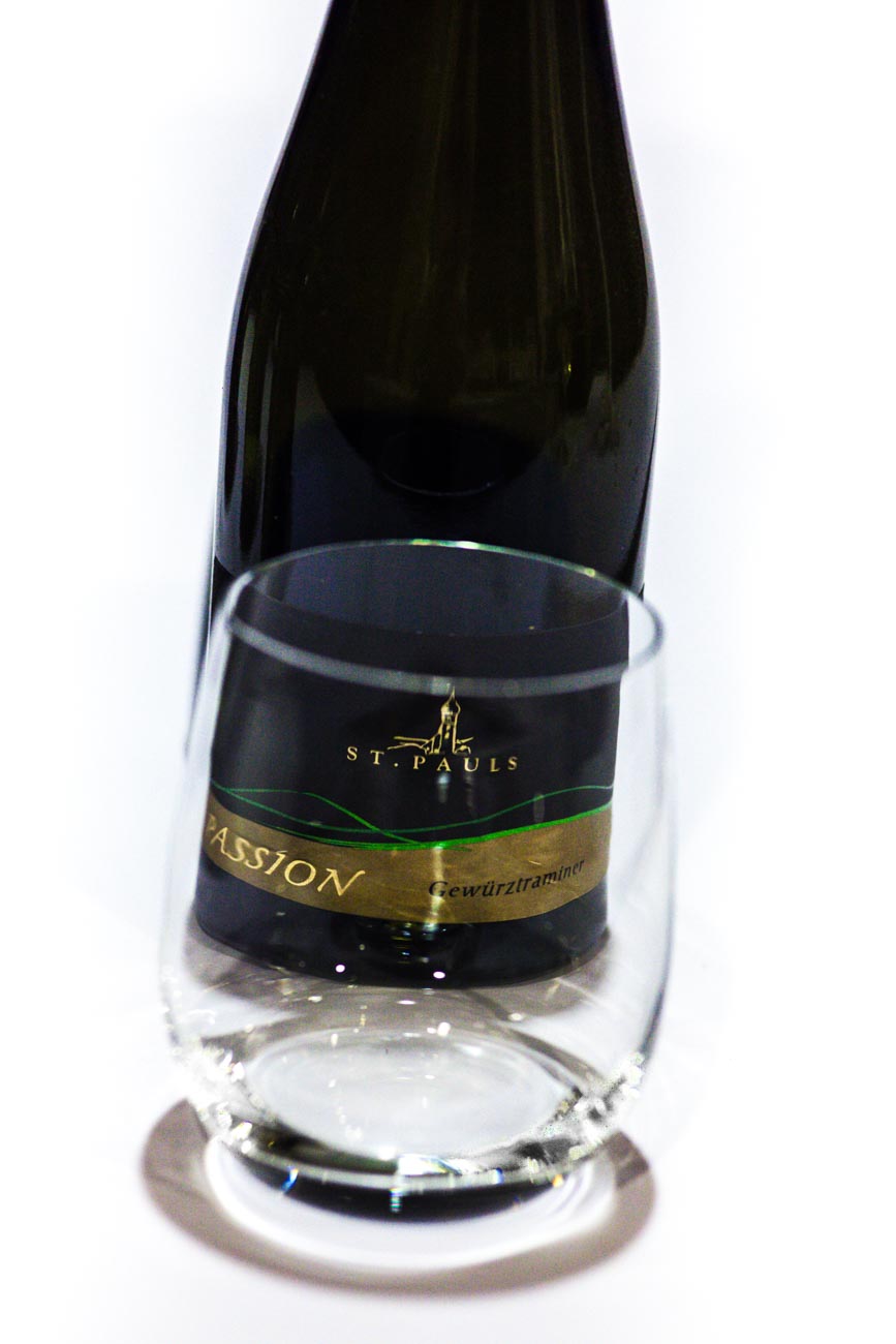 Bottle of wine with glass at angle