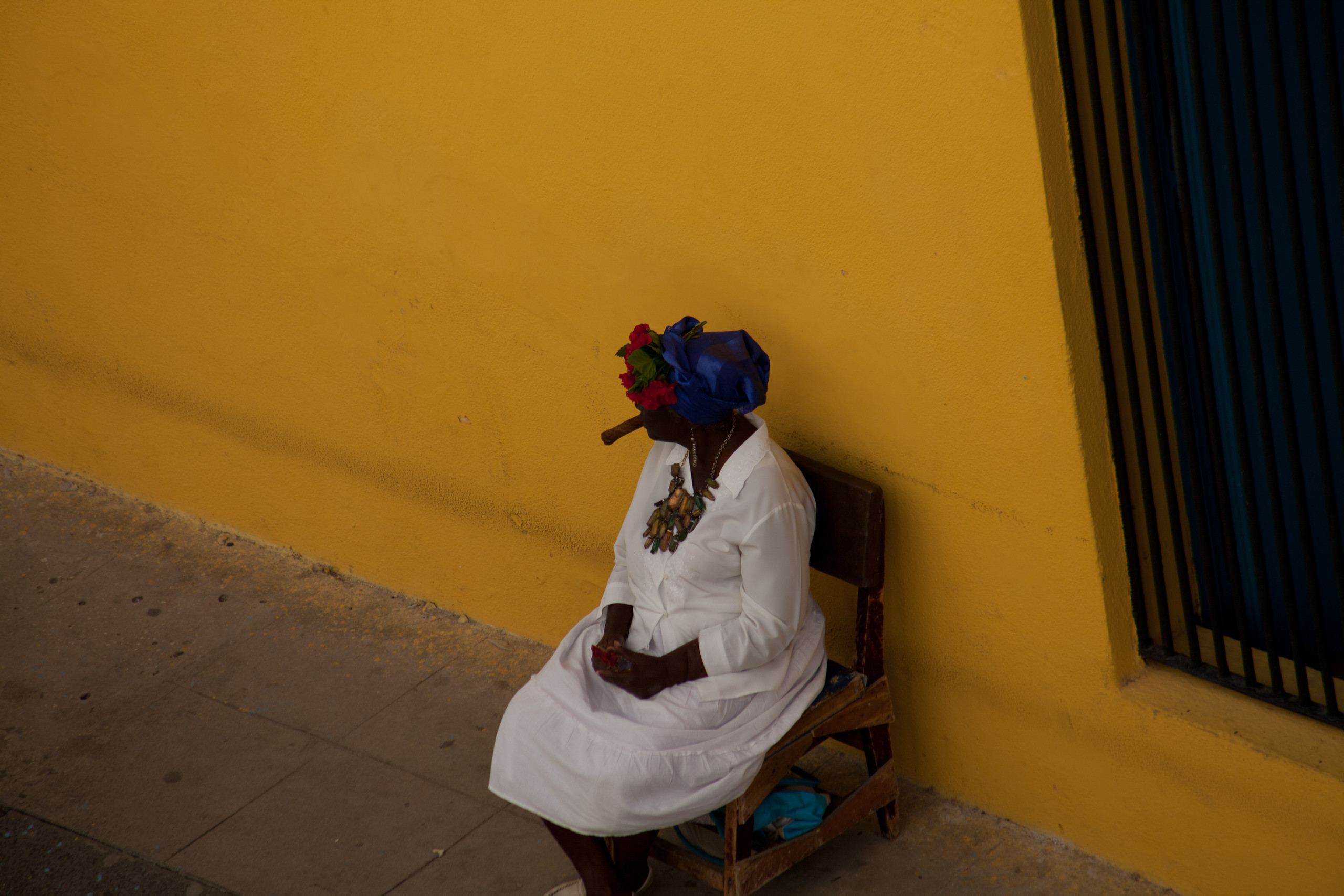Cigar smoking fortune teller near Catedral Plaza, Havana